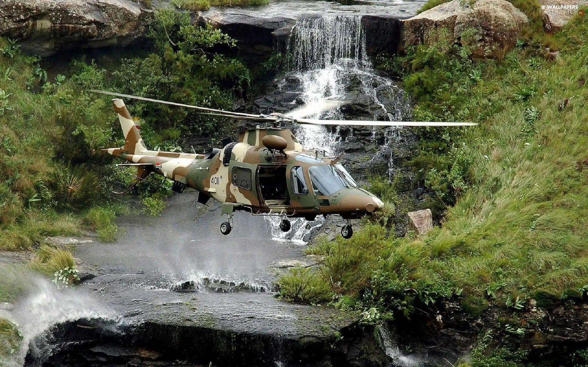 Helicopter, waterfall, rocks