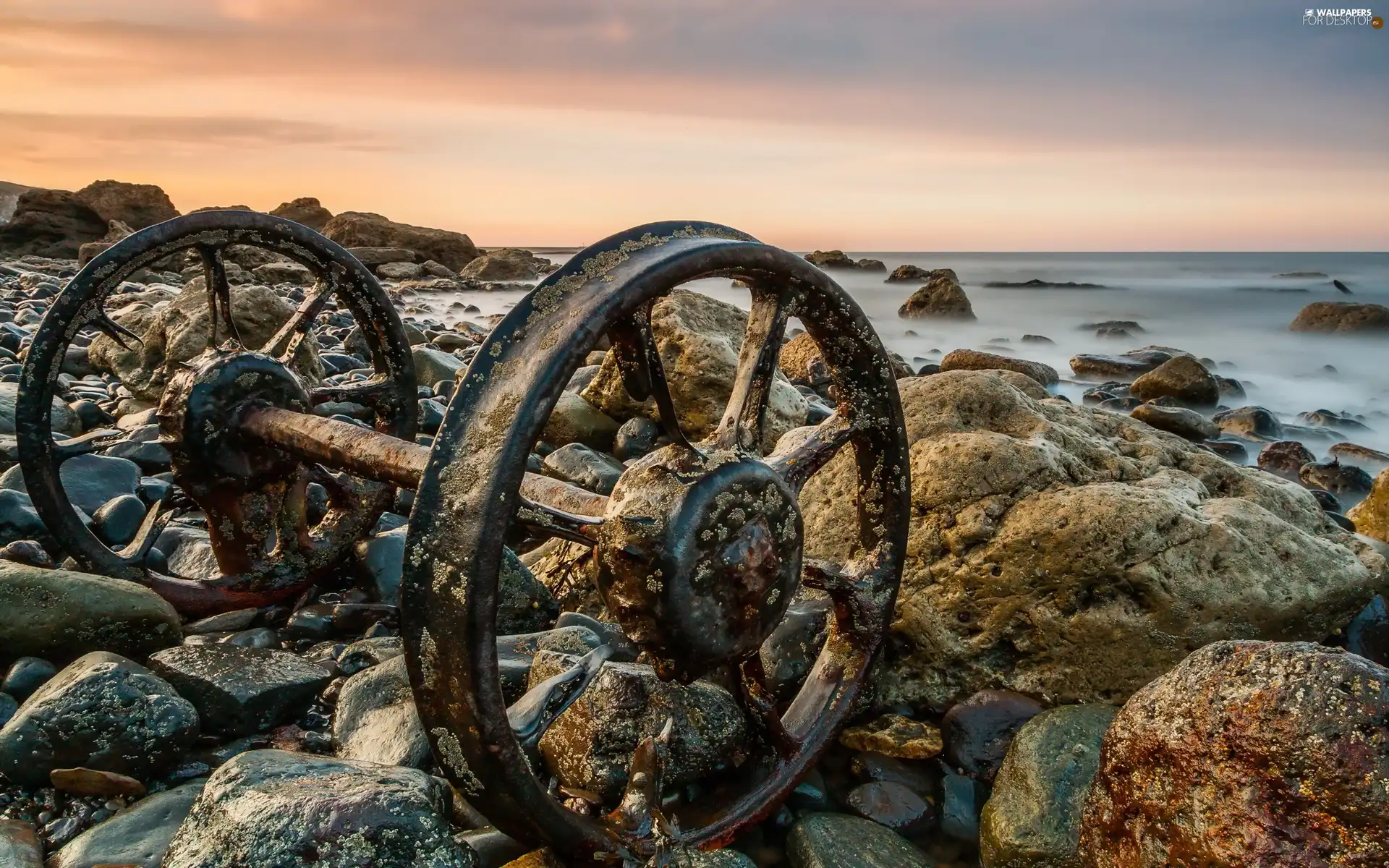 Stones, wheel, sun, sea, west