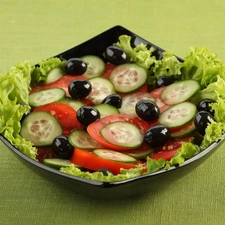 lettuce, cutlery, tomatoes, olives, cucumbers