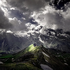 Mountains, clouds, light breaking through sky